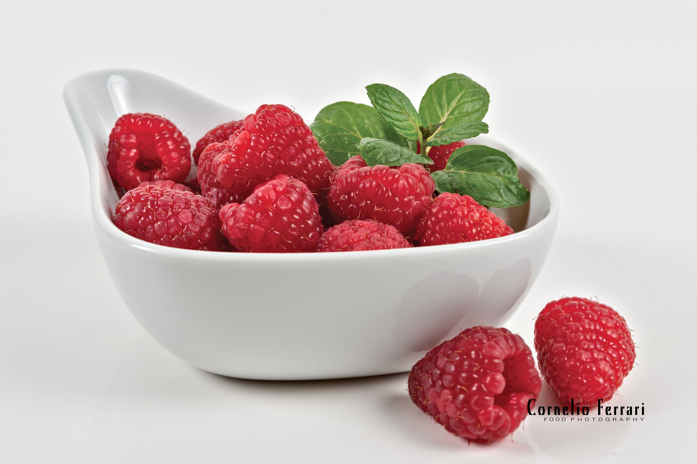 raspberries in white bowl...