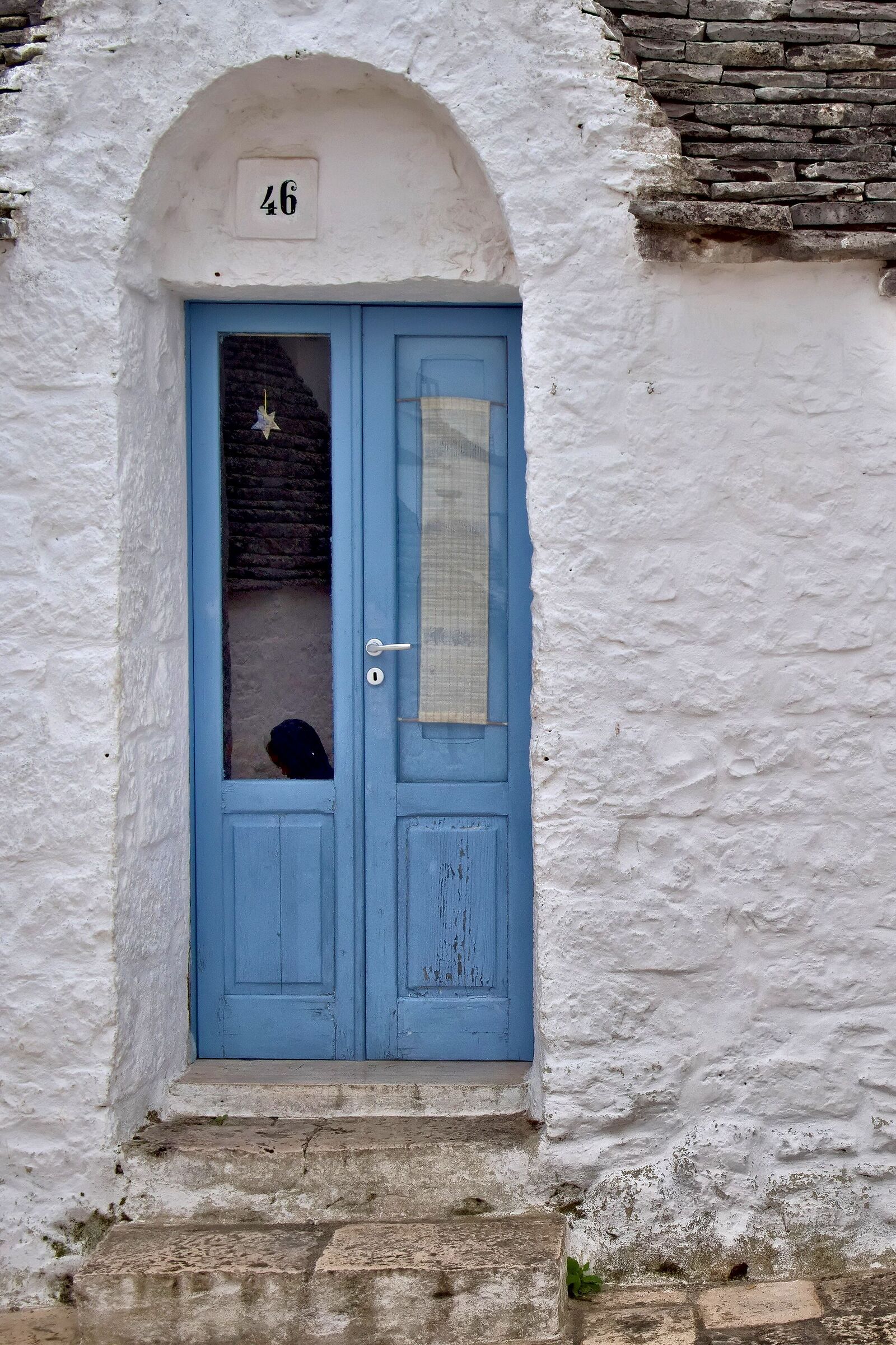 Face reflected on the door of the trullo...