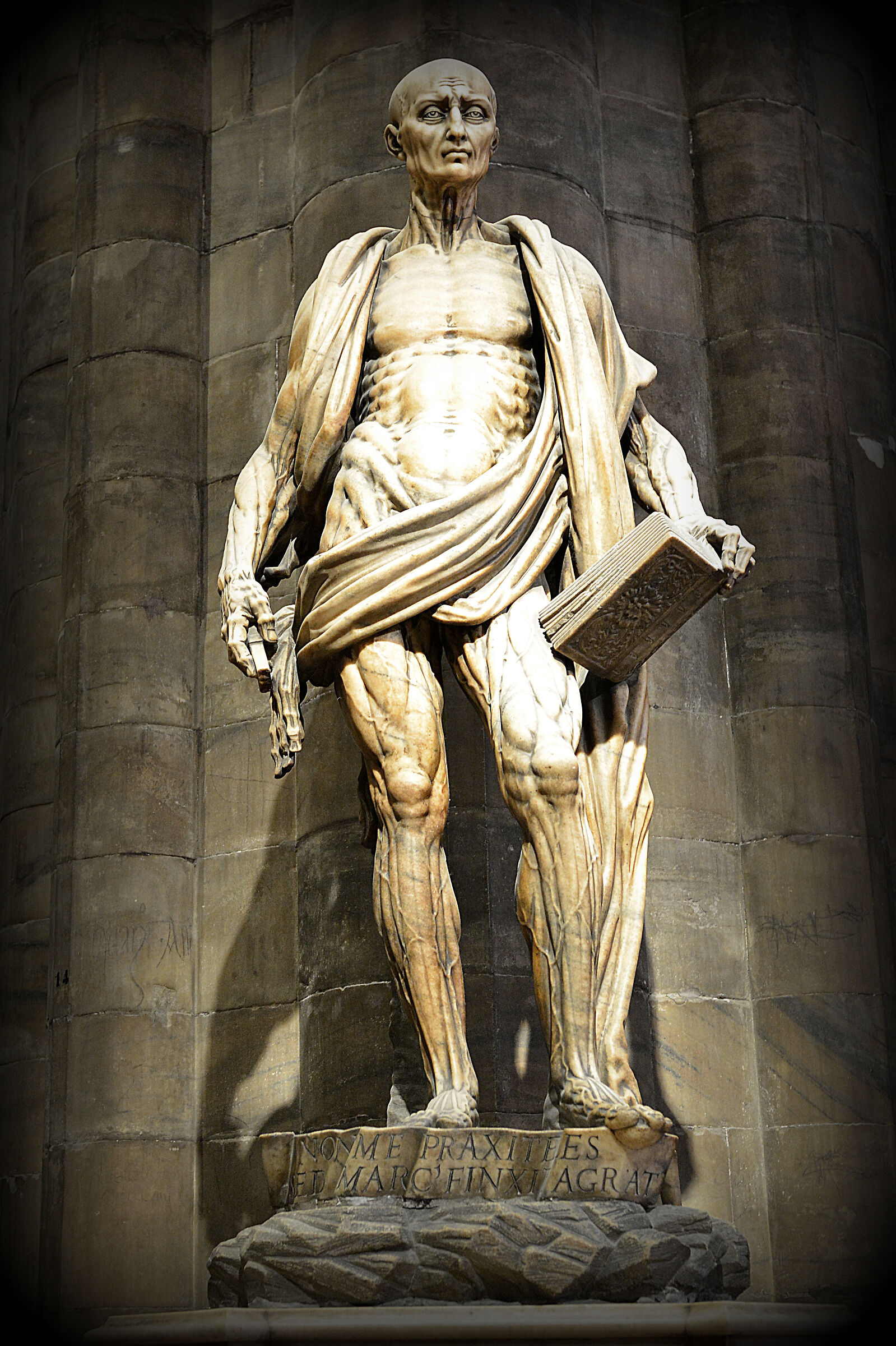 Cathedral. Statue of St. Bartholomew decorticated...