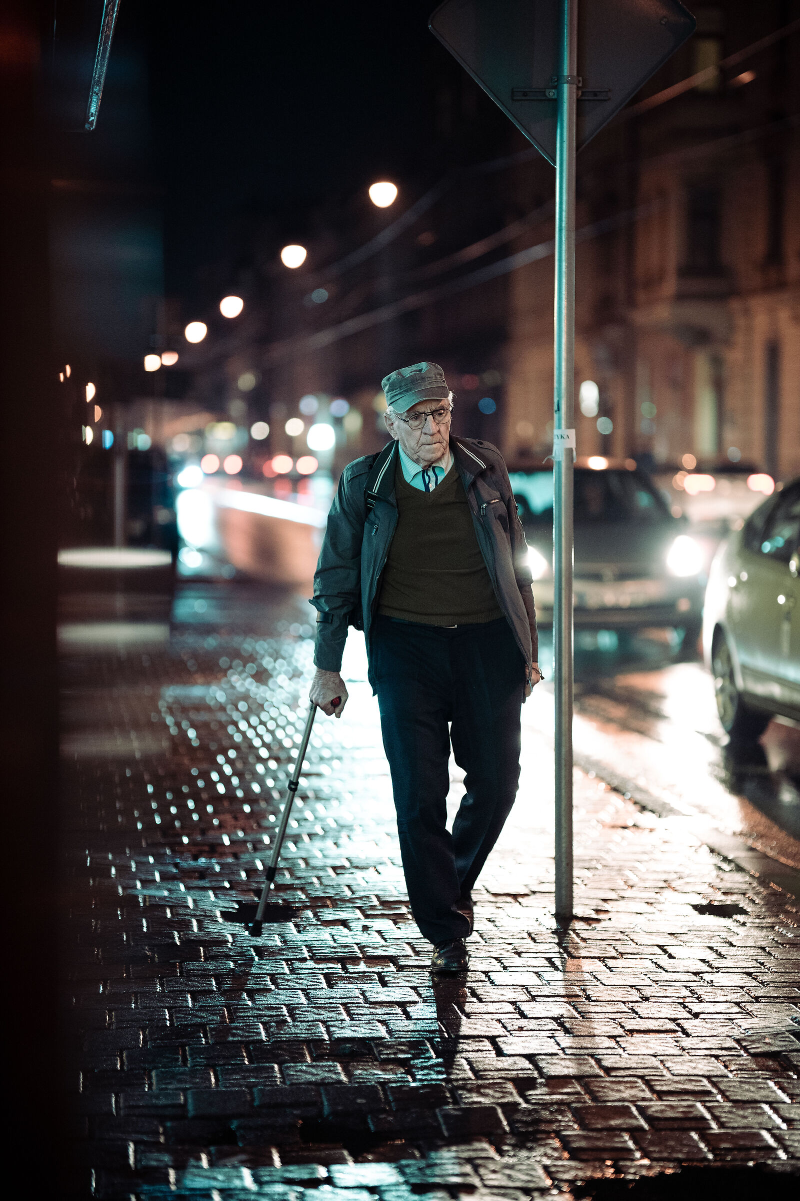 An elderly man walking at night...