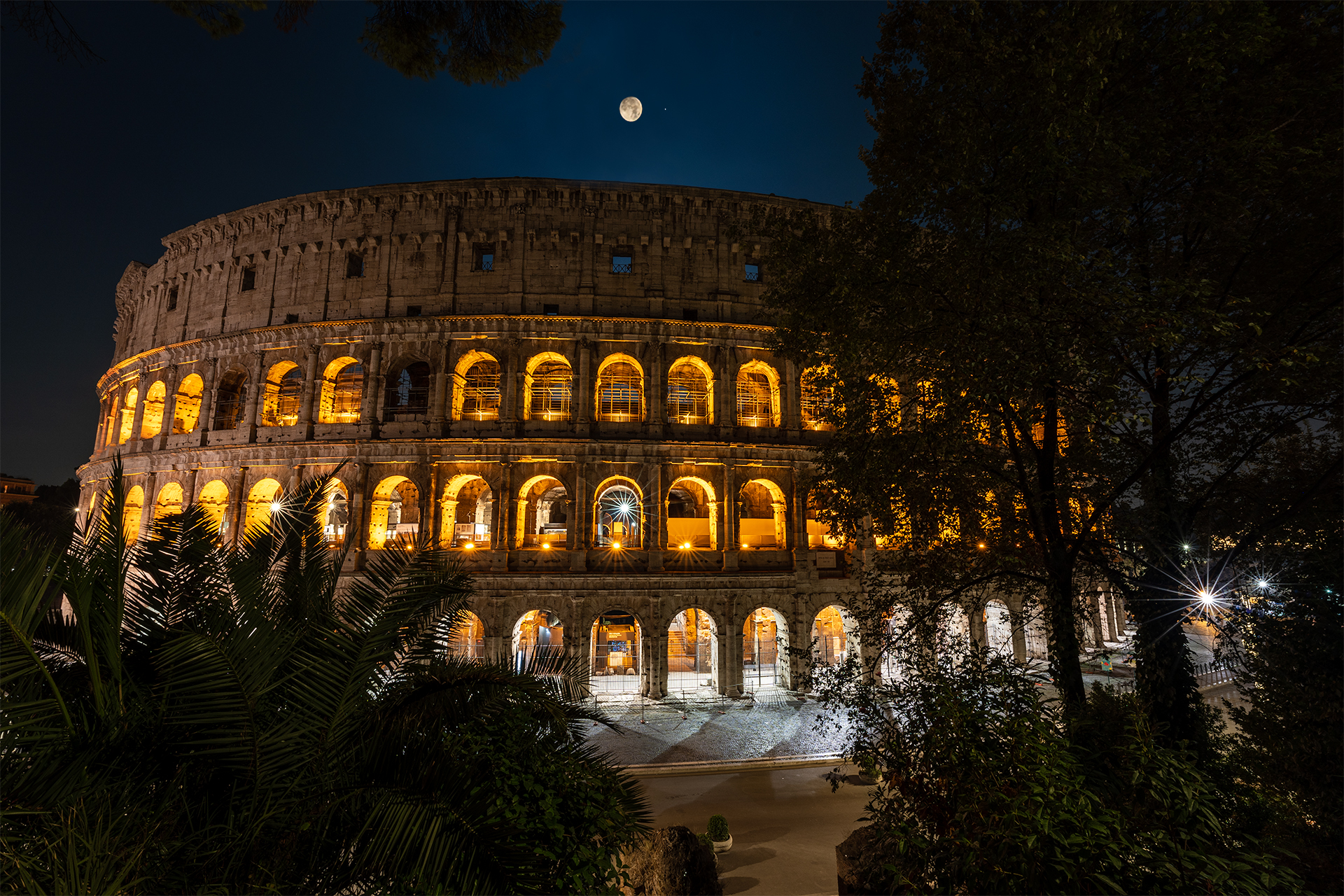The moon rises over the Colosseum...